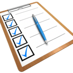 A clipboard with a checklist featuring several checked boxes and a blue pen on top.